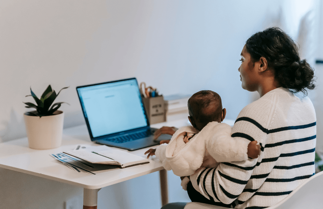 Woman and baby sitting at a computer